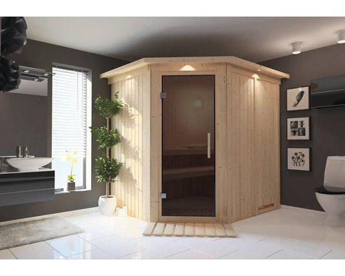 Plug & Play Sauna Karibu Achat VII inkl. 3,6 kW Ofen u.integr.Steuerung mit Dachkranz und graphitfarbeneer Ganzglastüre Ecksauna aus Holz mit Glastür in einem Badezimmer
