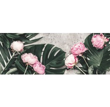 Arrangement aus rosa Pfingstrosen und grünen tropischen Blättern