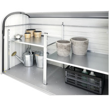 Innenansicht eines Gerätehauses mit Regalen und Gartenzubehör wie Gießkannen und Pflanzgefäßen.