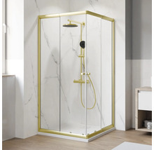 Eckdusche mit Duscharmatur und goldenen Rahmen vor weißer Wand