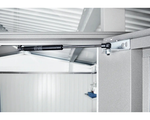 Detailaufnahme eines Gasdruckdämpfers an einem Metallrahmen