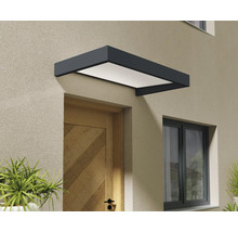 Modernes Vordach in Anthrazit mit weißer Abdeckung über einer hölzernen Haustür an einer verputzten Fassade.