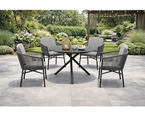 Gartenszene mit Esstisch und vier Stühlen im Freien.