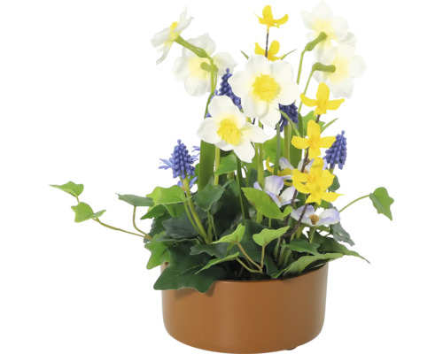 Dekorative Blumengesteck mit Narzissen, Traubenhyazinthen und verschiedenen Grünpflanzen in einem Pflanzgefäß.