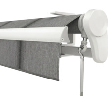 Senkrechtmarkise mit grauem Stoff, weißer Kassette und manueller Handkurbel.