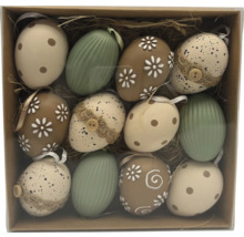 Ostereier-Set mit zwölf Stück in verschiedenen Mustern wie Punkten, Blüten und Streifen in einer Schachtel mit Stroh.