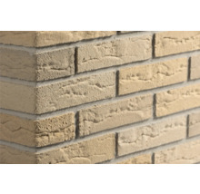 Beige Verblender in Steinoptik mit rauer Oberflächenstruktur an einer Wandecke.