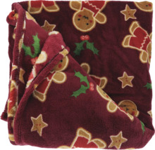Kuscheldecke aus weichem Plüsch mit weihnachtlichen Motiven wie Lebkuchenmännchen, Sternen und Stechpalmen.