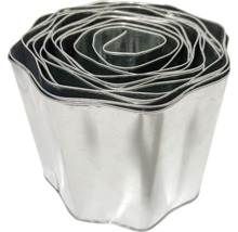 Gewellte Rasenkante aus verzinktem Metall in Rollenform zur Beetbegrenzung im Garten.