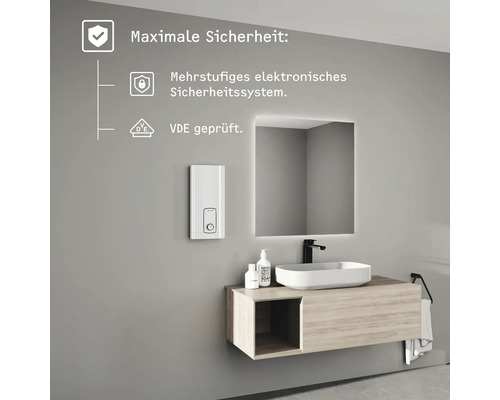 Moderner Waschtisch mit weißem Durchlauferhitzer, Aufsatzbecken auf Holzunterschrank und LED-Spiegel, inklusive elektronischem Sicherheitssystem.
