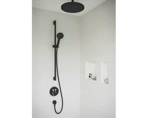 Modernes Duschsystem mit einer runden Kopfbrause, einer Handbrause an einer Brausestange und einer Unterputz-Armatur in einer Dusche mit Wandnischen.