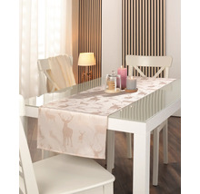 Tischläufer mit glitzernden Hirschmotiven auf einem weißen Glastisch in einem hellen, modernen Esszimmer.