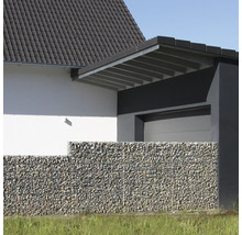 Moderner Gabionenzaun mit Steinfüllung vor einer Hausfassade mit Garage, hell und strukturiert gestaltet.