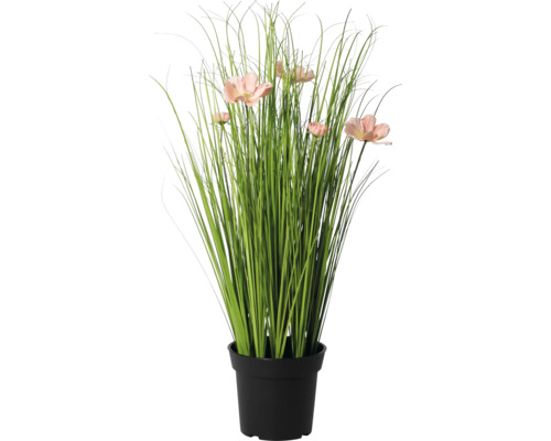 Künstliche Graspflanze mit rosa Blüten im schwarzen Topf.