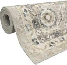 Teilweise aufgerollter Teppich im Vintage-Stil mit orientalischem Ornament-Muster und umlaufender Kettelung.
