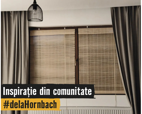 Modernes Fenster mit Bambusrollos, schweren grauen Vorhängen, einer schwarzen Gitter-Hängeleuchte und einem Heizkörper.