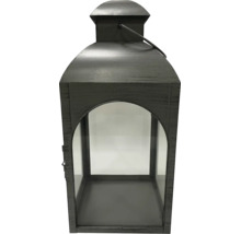 Dunkle Laterne aus Metall und Glas mit Tragegriff und bogenförmiger Öffnung.
