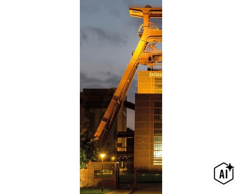 Das beleuchtete Fördergerüst der Zeche Zollverein in Essen bei Dämmerung. (Image AI modified or generated)