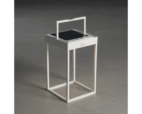 Weiße Solarlaterne mit Solarpanel auf einem grauen Untergrund