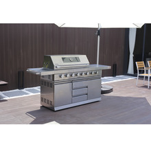 Edelstahl-Gasgrill mit mehreren Brennern, Schränken und Schubladen unter einem Sonnenschirm