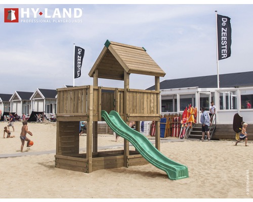 Spielturm mit Rutsche auf einem Sandstrand mit Personen und Strandhäusern