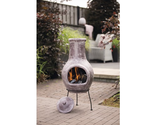 Chimenea aus Terrakotta mit offenem Feuer im Garten