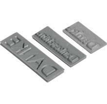 Drei Textstempel mit dem Wort Deluxe
