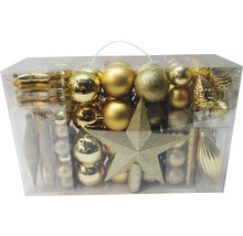 Sortiment goldfarbener Christbaumkugeln und Baumspitze in transparenter Verpackung
