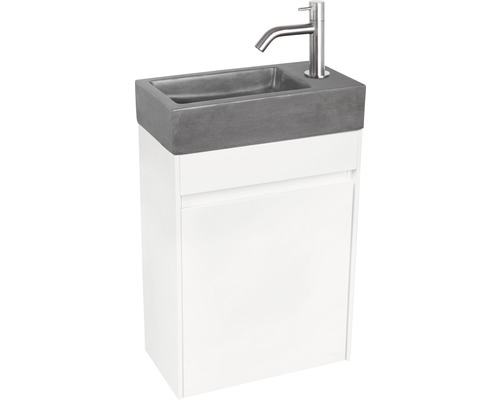 Waschtischkombination mit Betonwaschbecken und Armatur vor weißem Unterschrank