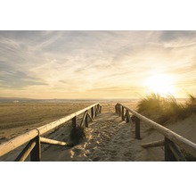 Holzsteg führt zum Strand bei Sonnenuntergang