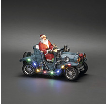 Weihnachtsdekoration mit Weihnachtsmann in Oldtimer mit Beleuchtung