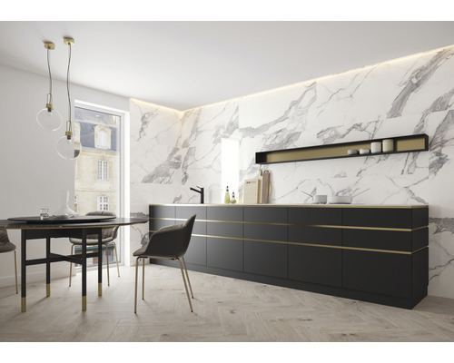 Heller Raum mit schwarzer Küchenzeile, Esstisch und Stühlen vor Marmorwand