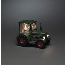 Dekorative Schneekugel mit Weihnachtsmann in einem Traktor