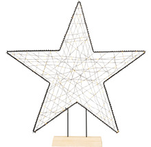 Dekorativer Stern mit Beleuchtung auf Holzsockel