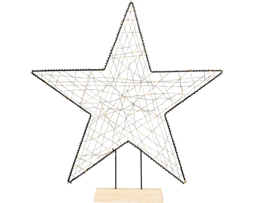 Dekorativer Stern mit Beleuchtung auf Holzsockel