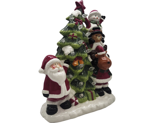 Weihnachtsdekoration mit Weihnachtsmann, Schneemann, Teddybär und Rentier neben einem Weihnachtsbaum mit Lichtern