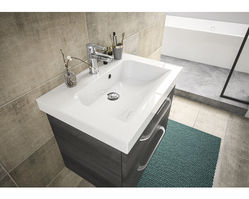 Badezimmerwaschtisch mit Waschbecken, Armatur und Schubladen vor Fliesenwand