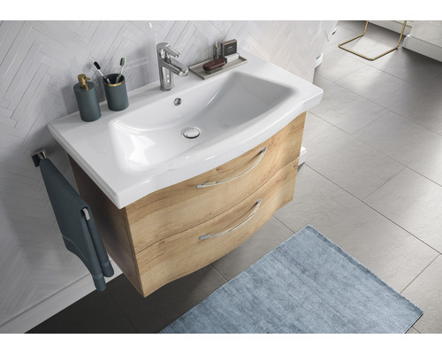 Waschtisch mit Unterschrank, zwei Schubladen und Armatur im Badezimmer.