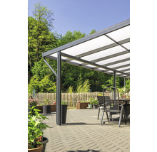 Terrassenüberdachung mit Gartenmöbeln auf gepflasterter Fläche