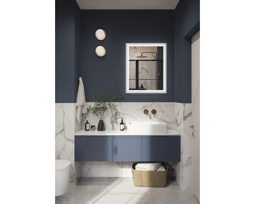 Modernes Badezimmer mit Waschtisch, beleuchtetem Spiegel und Dekoration