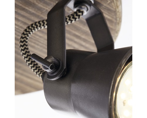 Detailaufnahme einer schwarzen Deckenleuchte mit Textilkabel