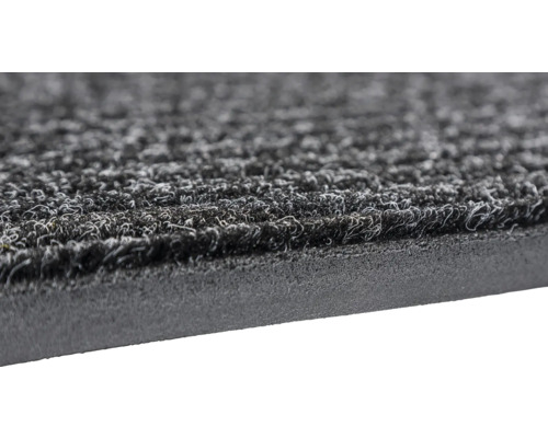 Detailaufnahme einer grauen Fußmatte mit Noppenstruktur und Gummirücken
