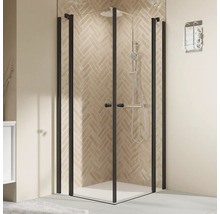 Eckdusche mit schwarzem Rahmen und Duschgarnitur vor beige gefliester Wand