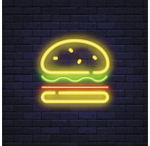 Neonreklame eines Burgers vor einer Backsteinmauer