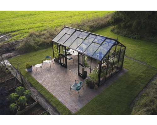 Außenansicht eines Gewächshauses mit Möbeln auf einer Terrasse