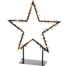 Sternförmige Weihnachtsdekoration mit Lichtern auf einem Ständer