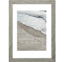 Gerahmtes Bild mit dem Text ''Glück kommt in Wellen'' und einer Fotografie von Strand und Meer