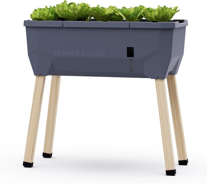 Gusta Garden Hochbeet Sammy Salad aus Kunststoff mit Holzbeinen, inklusive integriertem 15 Liter Wassertank und Wasserstandsanzeige.