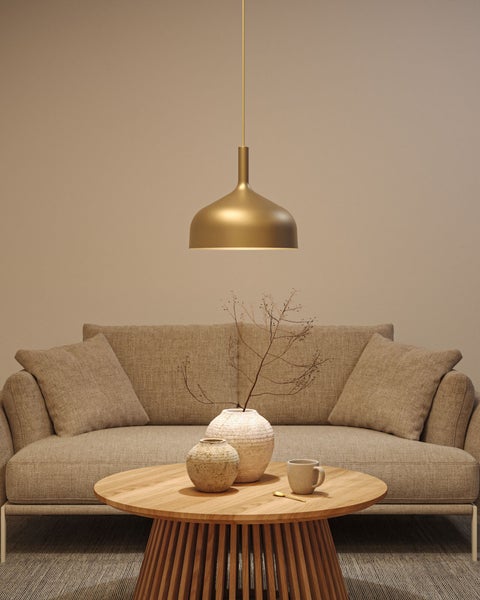 Wohnzimmer mit Sofa, Couchtisch und goldfarbener Hängelampe