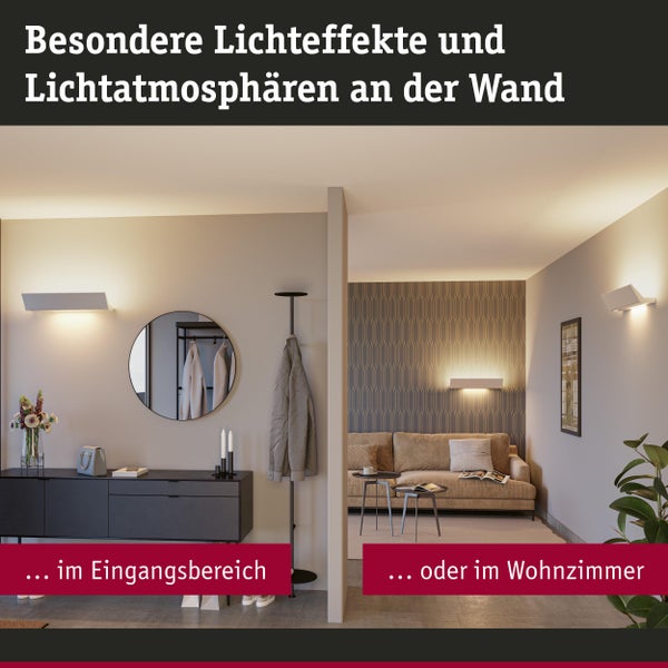 Wohnraum mit Wandleuchten für unterschiedliche Lichteffekte im Eingangsbereich und Wohnzimmer.